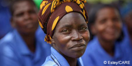 Woman in colorful headscarf looking at the camera with serious expression