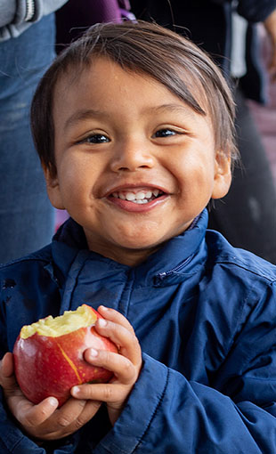 Child holding an Apple