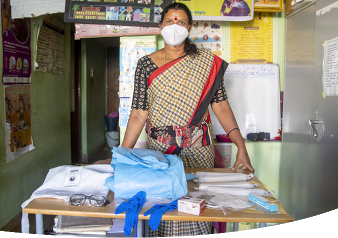 Indian woman with table of medical supplies.