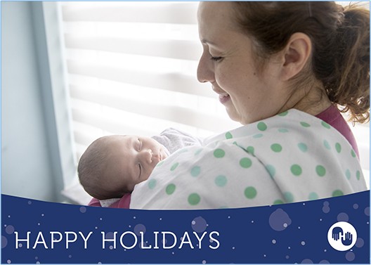 Holiday card showing mother holding newborn baby.