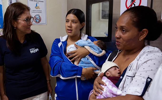 San Lorenzo de Los Mina Maternity Hospital in Santo Domingo. Francis leaves the NICU with her new triplets, helped by her mother-in-law. Her babies received care from Dr. Daphne Sanchez, and were in the NICU for two weeks. Also pictured is Teresa Narváez, National Director of Project HOPE.