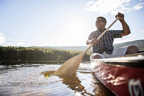 A person paddles a canoe.